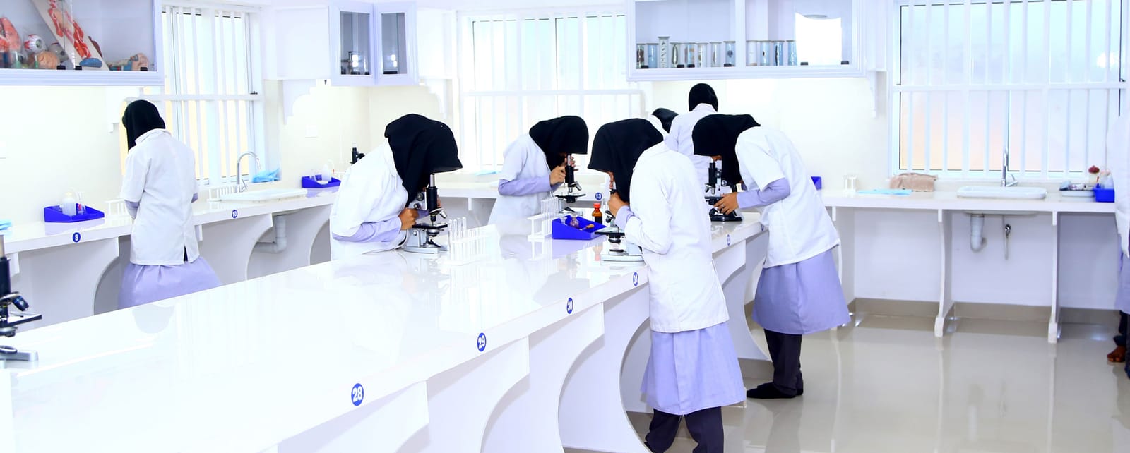 Students working in the Irshad English School science laboratory