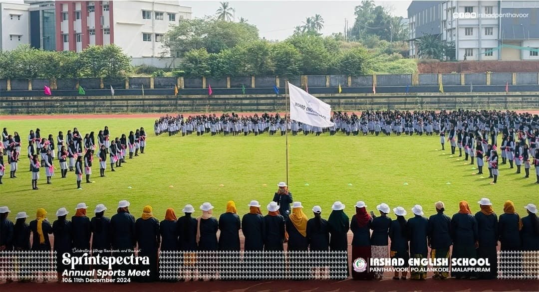Students forming a heart around the school flag at the Sprintspectra Annual Sports Meet 2024